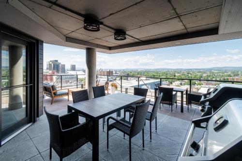 a patio with a table and chairs on a balcony at 2 Bedroom condo - 800M of Old Quebec ! in Quebec City
