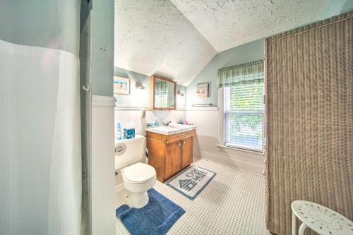 a bathroom with a toilet and a sink and a shower at Private Waterfront Lake Erie Home with BBQ Patio in Saybrook