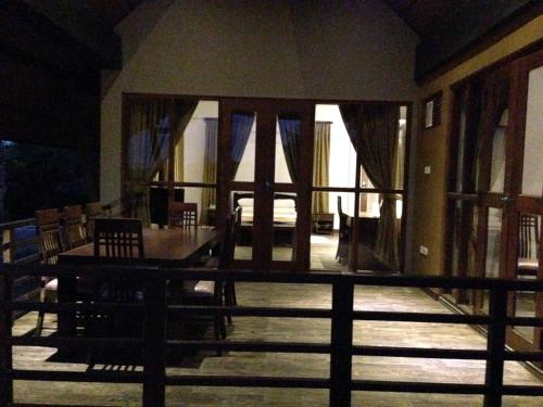 a dining room with a table and chairs on a balcony at Laya Safari Resorts & Spa in Yala