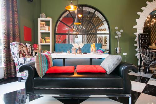 a leather couch in a room with a table at Bed & Breakfast Twenty in Kikinda