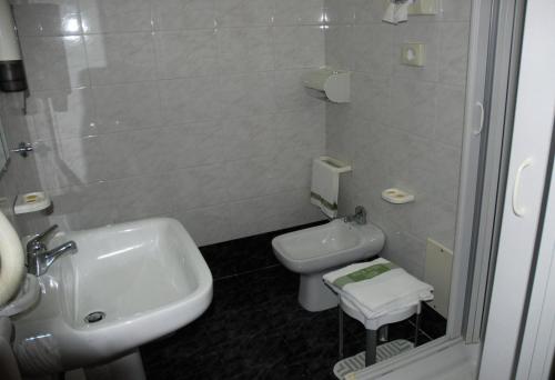 a bathroom with a sink and a toilet and a shower at Hotel Grillo Verde in Torre Annunziata