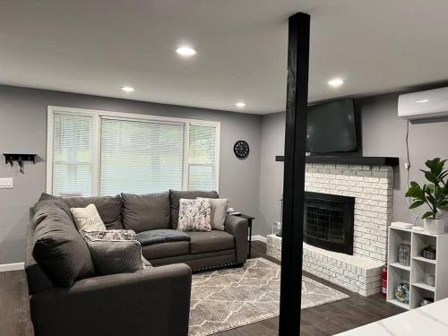a living room with a couch and a fireplace at Casa Rosado @ Pocono II by Lake Hot Tub Camelback in Tobyhanna