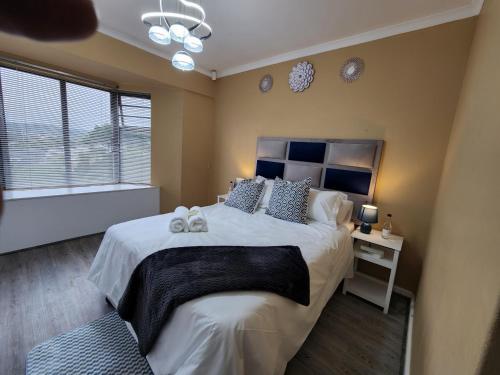 a bedroom with a bed with two stuffed animals on it at Asher's Place in East London