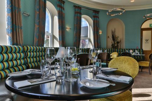 a dining room with a table with glasses on it at Westville Hotel in Enniskillen