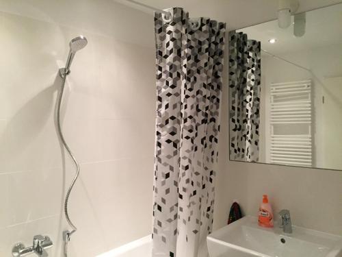 a shower curtain in a bathroom with a sink at Potsdamer Platz-Top Spot Studio 1 in Berlin