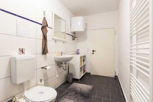 een badkamer met een toilet en een wastafel bij Bergmann Kiez. The place to be! in Berlijn