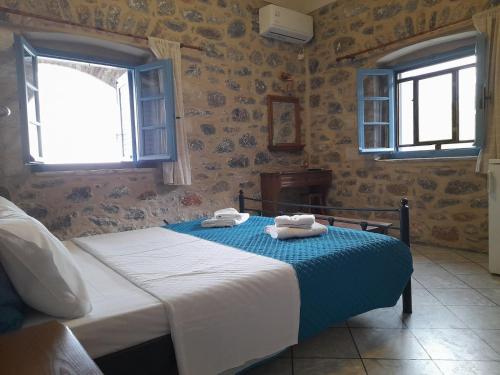 a bedroom with a bed with towels on it at Marathos Bay in Kokkala