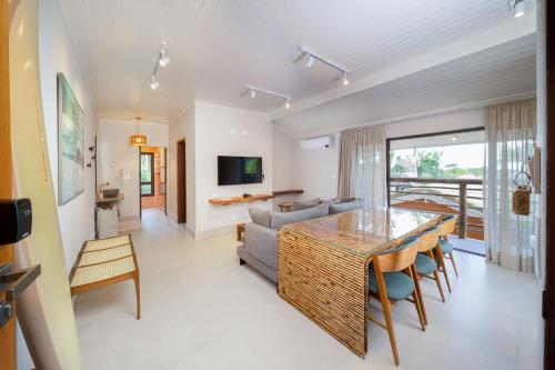 a living room with a table and a couch at Øko Villa in Juquei