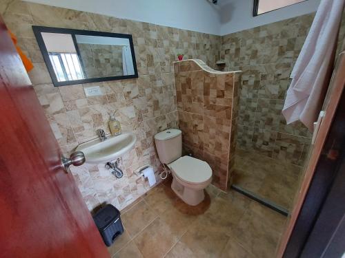 a bathroom with a toilet and a sink and a shower at Donde Andres Campestre - Guatape in El Peñol