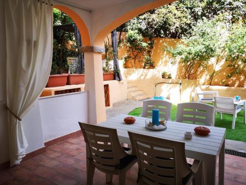 una mesa y sillas en un patio en Insardinia House trilocale a 200mt dalla spiaggia en Olbia
