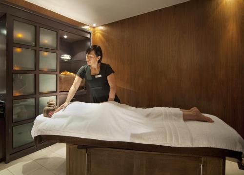 
a woman laying on a bed in a room at K West Hotel & Spa in London
