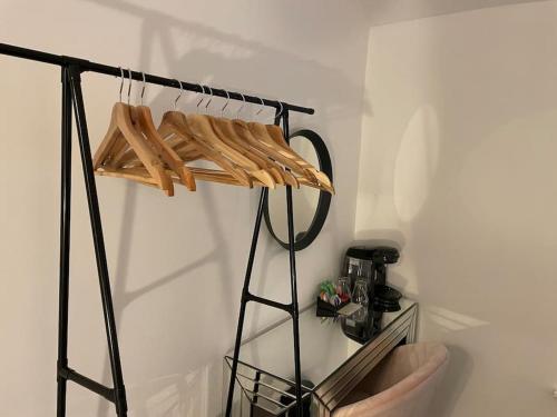 a room with a shelf with wooden hangers at Hill Garth Cottage - Luxury 2 Bed with Wood Burning Hot Tub in Wooler