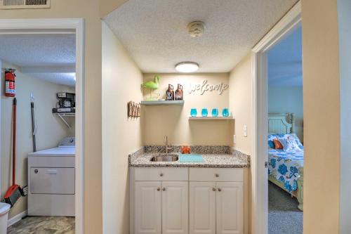 a bathroom with a sink in a room with a bed at Emerald Isle Condo with Indoor Pool and Beach Access! in Emerald Isle