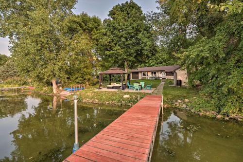 a wooden boardwalk leading to a house on a river at Hugo Home, Direct Lake Access and Private Dock! in Hugo