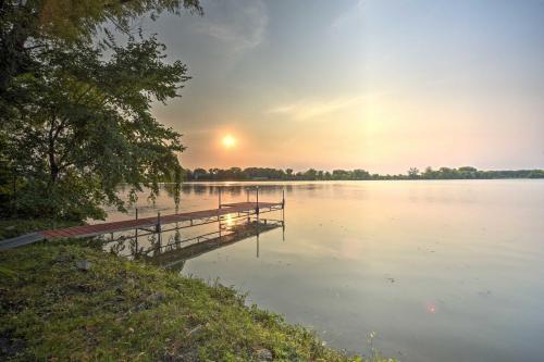 a dock on a lake with the sun setting at Hugo Home, Direct Lake Access and Private Dock! in Hugo