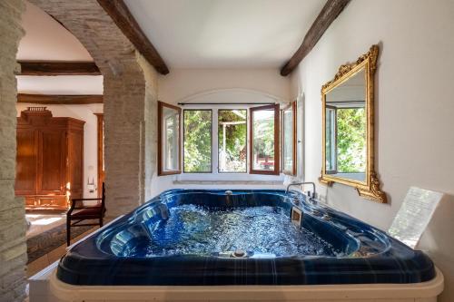 a large blue tub in a room with windows at Corte Cristina in Quartucciu