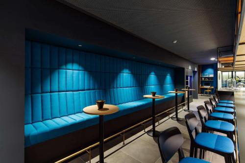 a row of tables and chairs in a bar at elaya hotel goeppingen in Göppingen