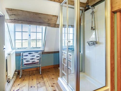a bathroom with a shower with a glass door at Hemblington Hall Arts And Leisure Ltd in South Walsham