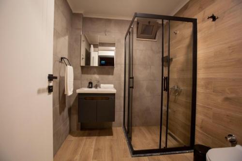 a bathroom with a shower and a sink at Eva Apart Kemer in Kemer