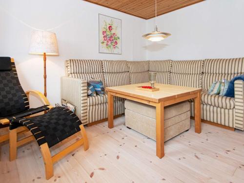 a living room with a table and a couch at 5 person holiday home in Sydals in Trænge
