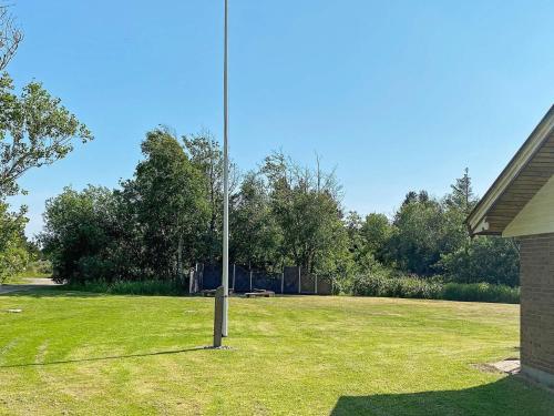 a pole in the middle of a grass field at 8 person holiday home in R m in Lakolk