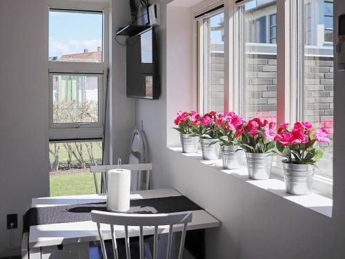 a table with pink flowers on a window sill at 2 person holiday home in VARBERG-By Traum in Varberg