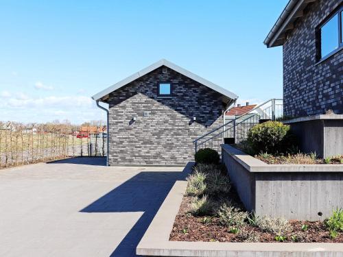 a brick building with a shadow on the side of it at 2 person holiday home in VARBERG-By Traum in Varberg