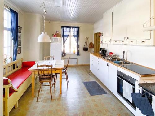 a kitchen with a table and chairs in a room at Holiday home LYCKSELE in Lycksele