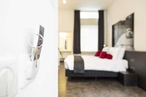a bedroom with a bed and a mirror at Zimmerhof Hotel in Lier