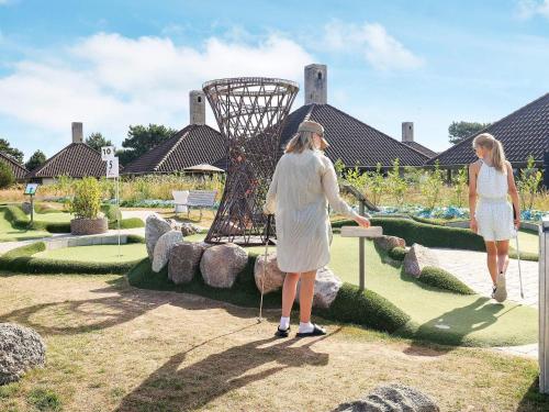 two women are looking at a sculpture in a park at Inviting holiday home in Karrebæksminde in Karrebæksminde
