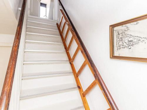 a staircase in a house with a picture on the wall at 3 person holiday home in r sk bing in Ærøskøbing