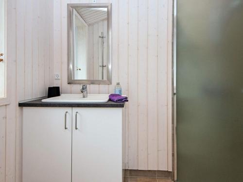 a bathroom with a sink and a mirror at 8 person holiday home in Glesborg-By Traum in Glesborg