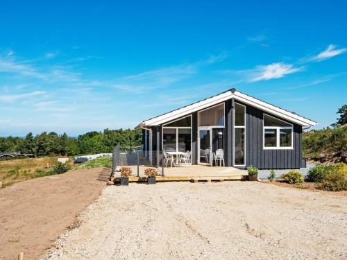 a house on a dirt lot with a large glass at 8 person holiday home in Glesborg-By Traum in Glesborg