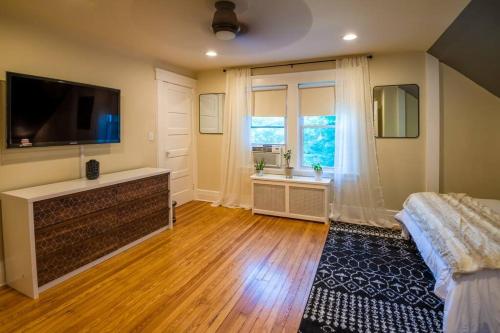 a large bedroom with a television and a bed at Immaculate, Newly Renovated 1 Bedroom Apt Near NYC in Hawthorne