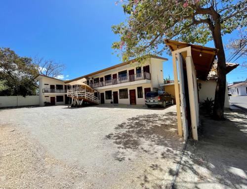 a building with a car parked in front of it at Hotel Wilson Condega in Liberia