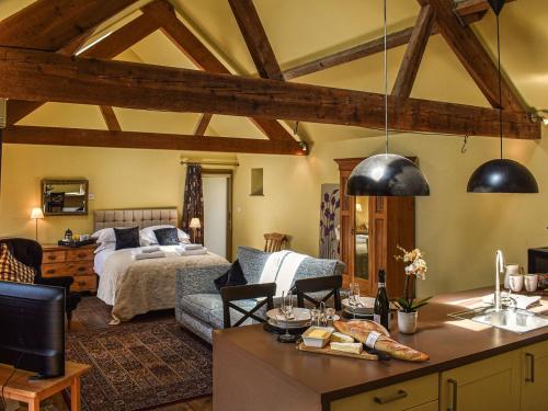 a living room with a bedroom and a bed at The Byre in Helmsley