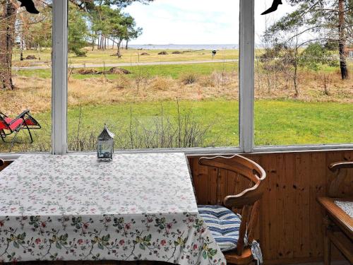 a dining room with a table and a view of a field at 8 person holiday home in BERGKVARA in Bergkvara