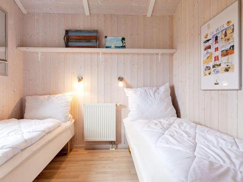 格洛米茨的住宿－Two-Bedroom Holiday home in Grömitz 1，配有粉红色墙壁的客房内的两张床