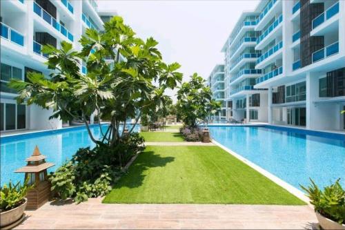 a swimming pool in the middle of a building at Light, airy, east facing 2 bed/2 bath pool views in Hua Hin