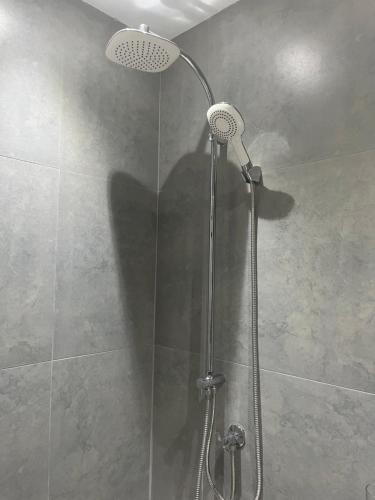 a shower with a shower head in a bathroom at Boca Simon Vacation Curacao in Willemstad