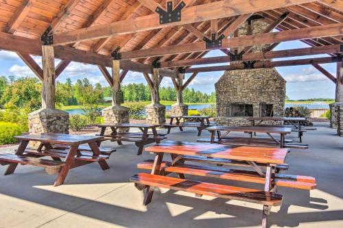 a group of picnic tables in a pavilion with a fireplace at Tranquil Deck Blue Ridge Mountain Retreat! in Nebo