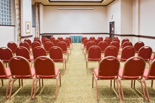 an empty room with red chairs and a projection screen at Holiday Inn Express Hotel & Suites Portland-Northwest Downtown by IHG in Portland
