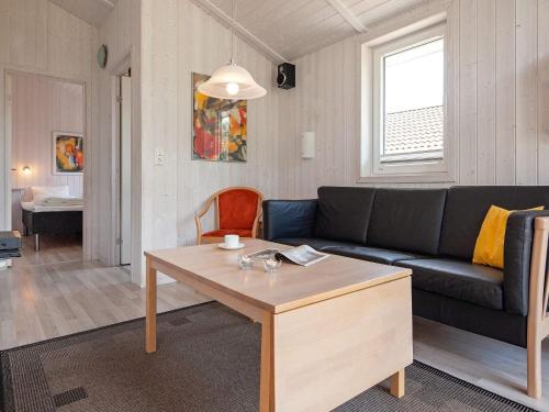 a living room with a couch and a table at Two-Bedroom Holiday home in Grömitz 20 in Grömitz