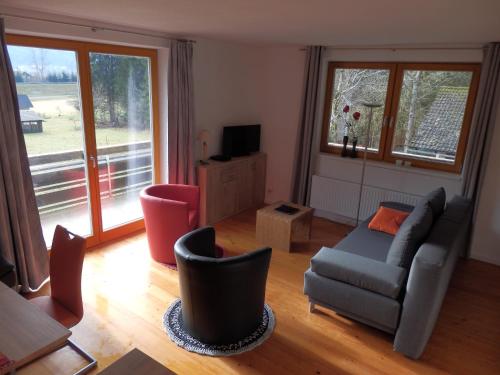 a living room with a couch and chairs at Ferienhaus Bella Vista in Presseggersee