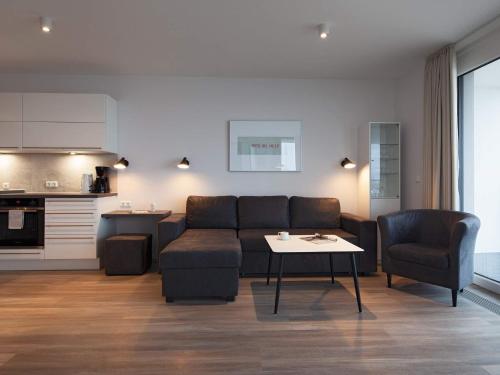 a living room with a couch and a table at 6 Personen Ferienhaus in Wendtorf in Wendtorf
