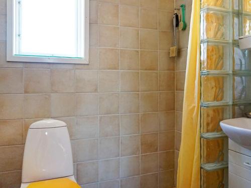 a bathroom with a toilet and a sink and a window at Holiday home FISKEBÄCKSKIL IV in Fiskebäckskil