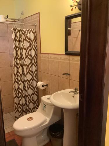 a bathroom with a toilet and a sink at La casita de Angie in Antigua Guatemala