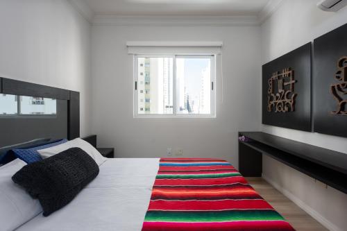 a bedroom with a bed with a colorful rug on the floor at Apartamento DES ARTS-Vista Mar in Balneário Camboriú