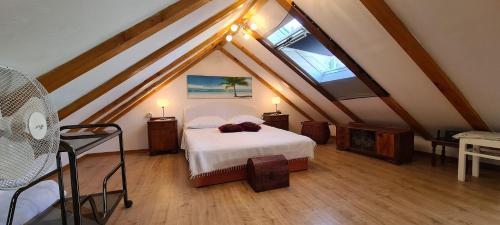 a bedroom with a bed in a attic at House Old town stone house in Stari Grad