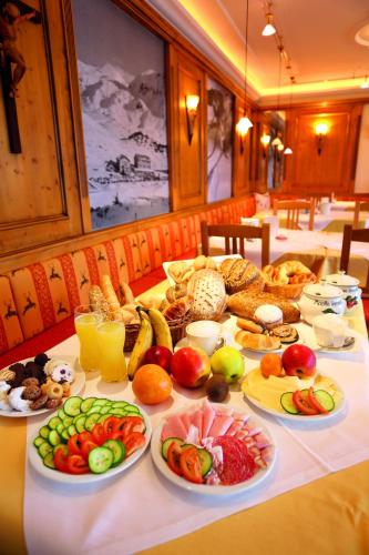 a table with many plates of fruits and vegetables on it at Hotel Binggl in Obertauern